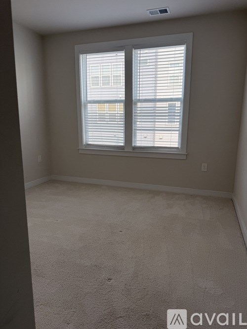 A room with a window covered in blinds.