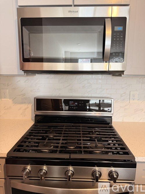 A stainless steel oven with a microwave above it.