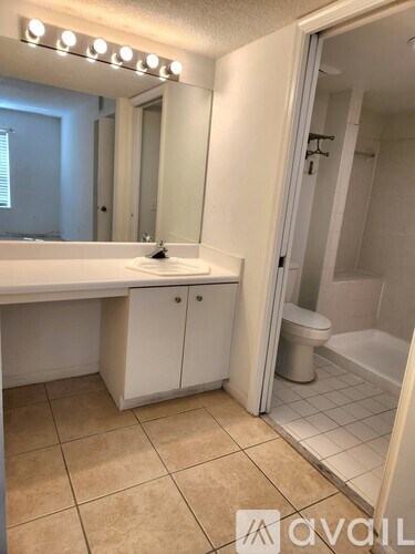 A bathroom with a sink, mirror, and cabinets.