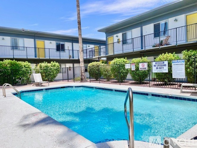 A pool in front of a building with a sign that says "No Pets Allowed".