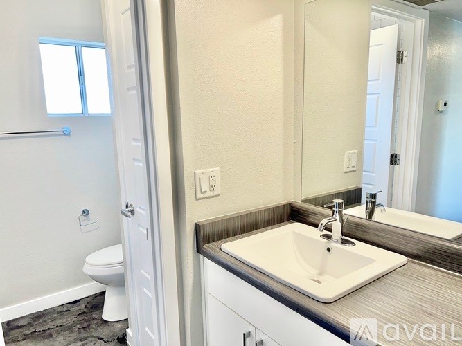 A bathroom with a white toilet and a white sink.