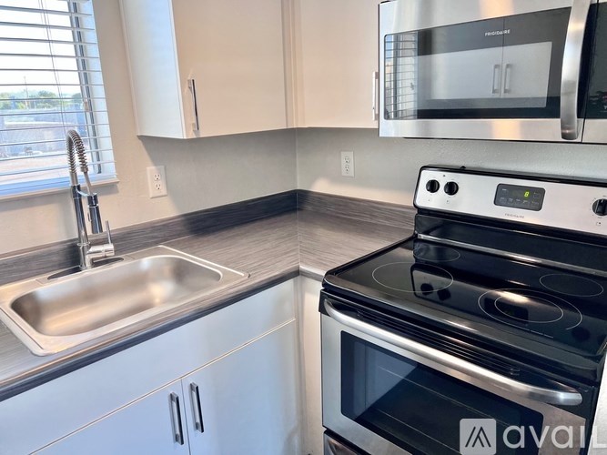 A modern kitchen with a stainless steel oven and microwave.