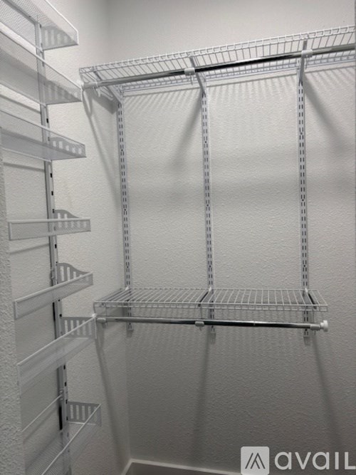 A white metal shelving unit with multiple shelves.