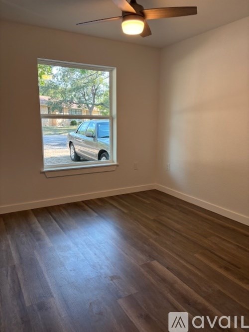 A room with a window and a ceiling fan.