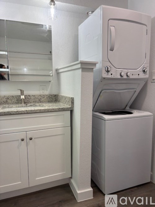 A white washing machine in a laundry room.