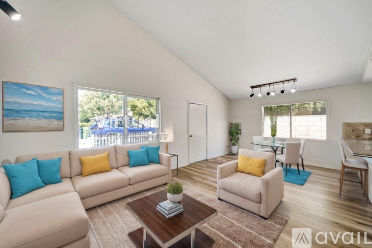 A living room with a couch, chairs, and a coffee table.