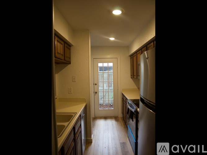 A kitchen with a view of a balcony through the door.