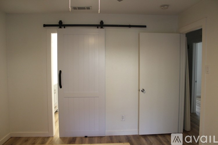 A room with a sliding door and a wall-mounted light fixture.