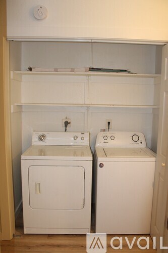 A white bathroom with a sink and toilet.