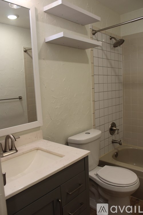 A bathroom with a toilet, sink, and bathtub.