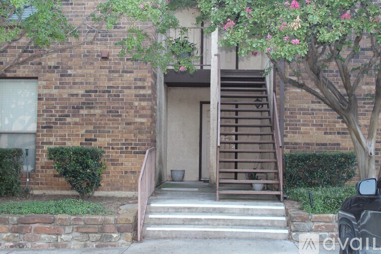 A brick building with a tree in front of it.