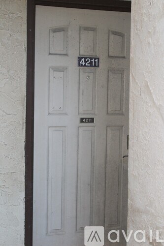 A white door with the number 4211 on it.