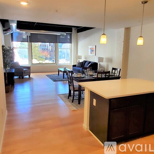 A modern kitchen with a bar area and a dining table.