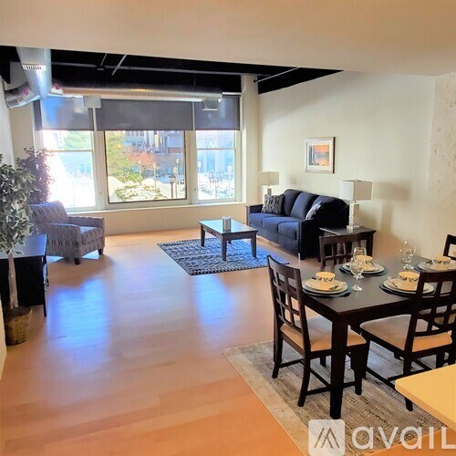 A living room with a dining table set for four.