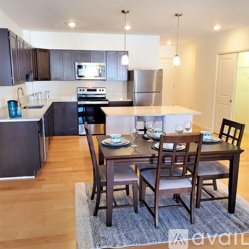 A kitchen with a dining table set for two.
