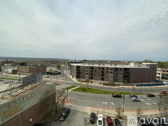 A view of a parking lot with cars and a building with the name "LawallACE AMERICA" on it.