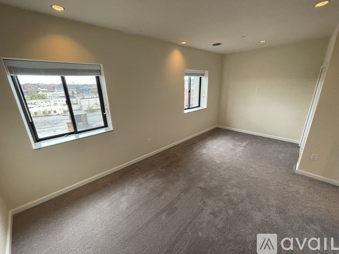 A room with a large window and a smaller window on the wall.