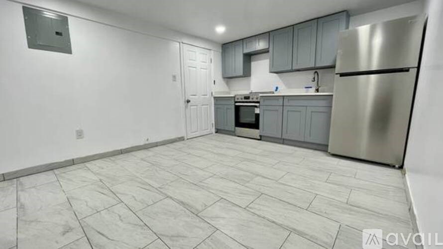 A kitchen with a refrigerator, microwave, and oven.