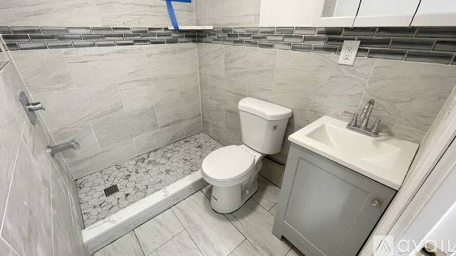 A bathroom with a toilet and sink.