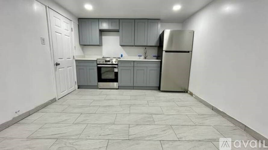 A kitchen with a refrigerator, stove, and oven.