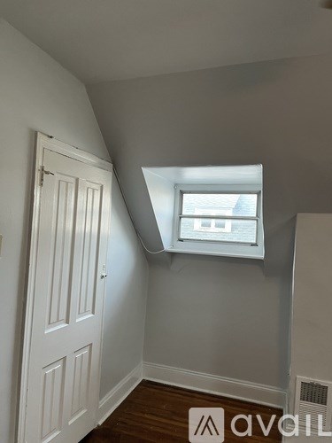 A white door is on the left and a window with white trim is on the right.