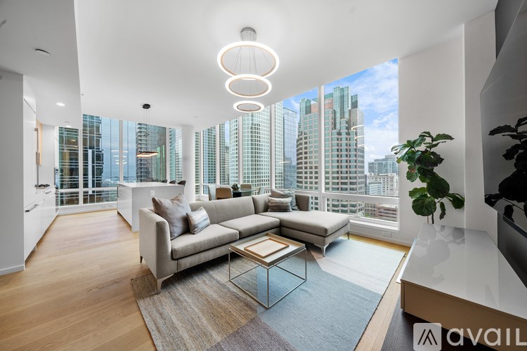 A modern living room with a large window overlooking a cityscape.