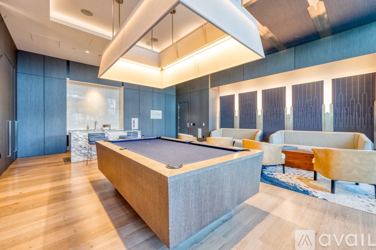 A modern room with a pool table and a couch.