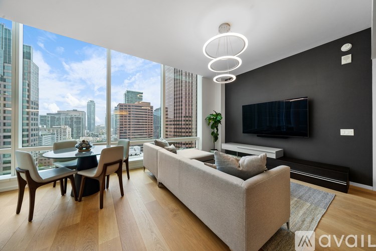 A modern living room with a view of the city skyline.