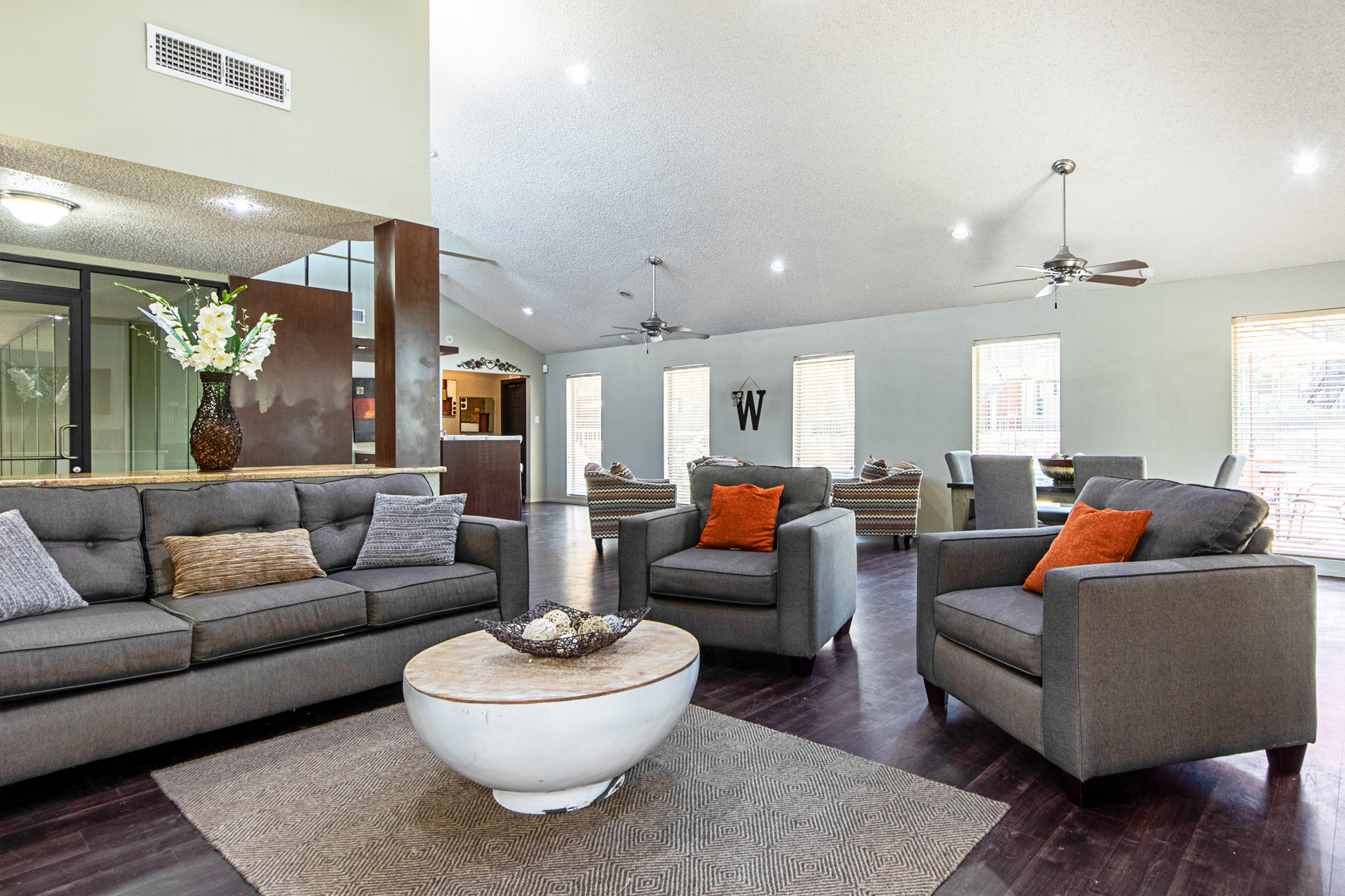 A living room with grey couches and a white coffee table.