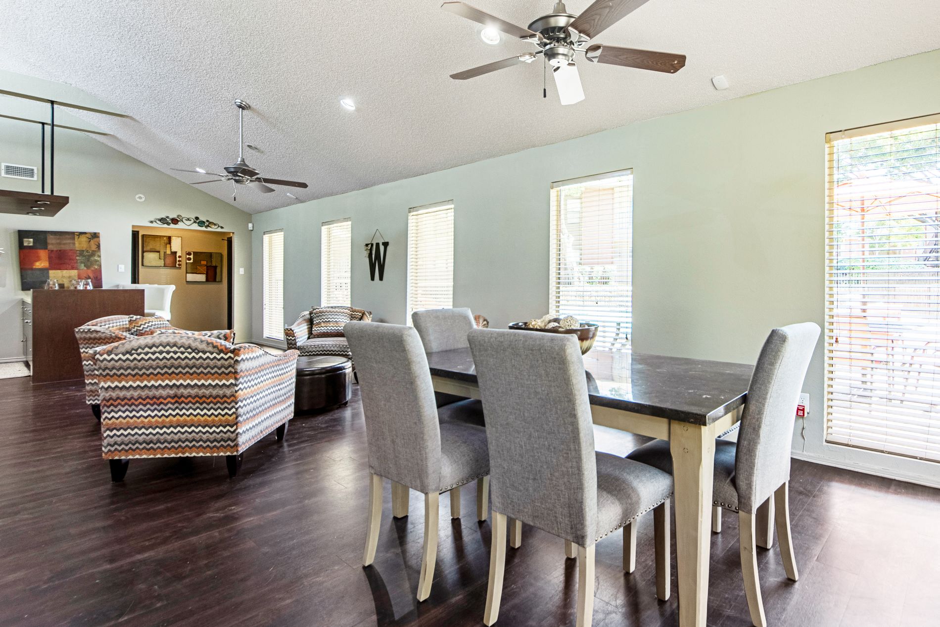 A dining room with a table and chairs.