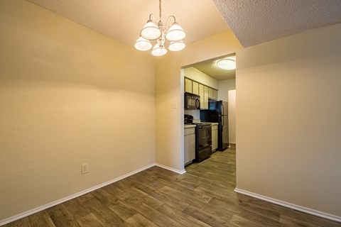 A kitchen area with a refrigerator, microwave, and oven.