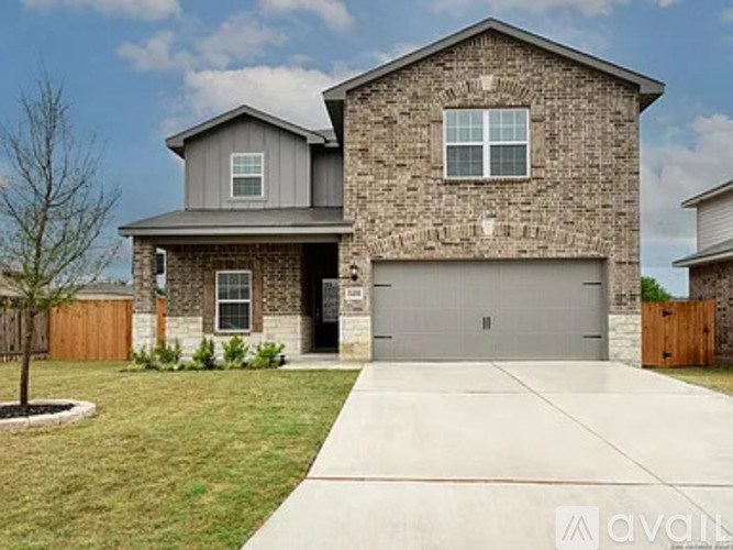A two-story house with a garage is for sale.