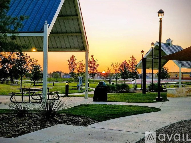 A park with a bench and a lamp post.