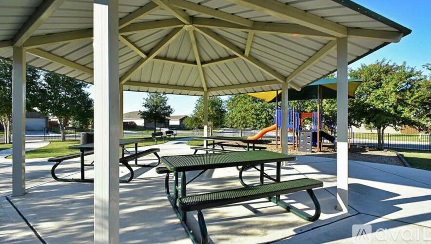 A covered picnic area with tables and benches.