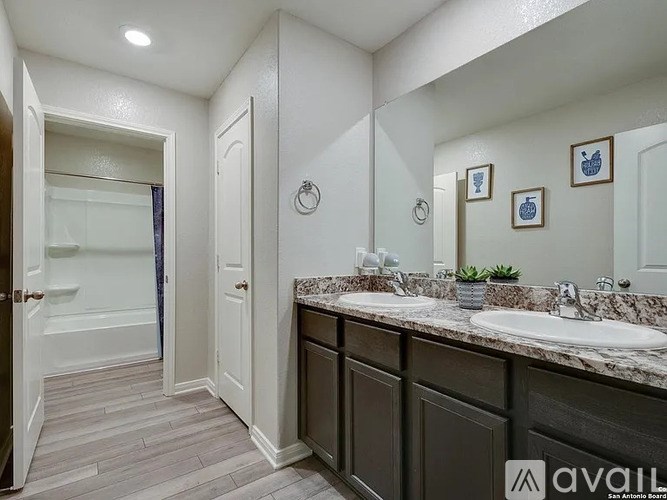 A bathroom with a marble countertop and a walk-in shower.