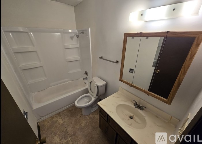 A bathroom with a toilet, sink, and bathtub.