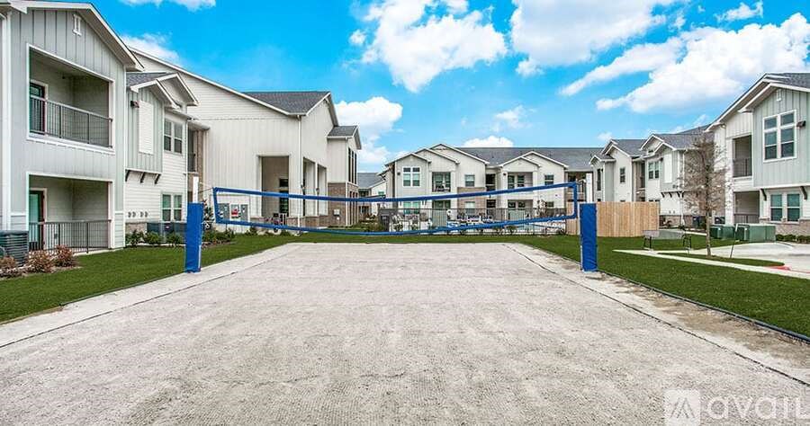 A row of houses with a blue fence in front.