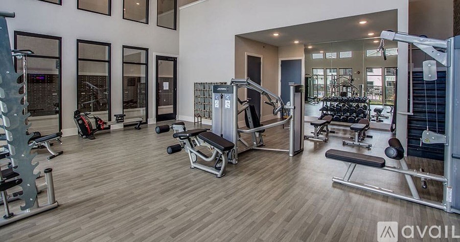 A gym with a variety of equipment including weights and machines.