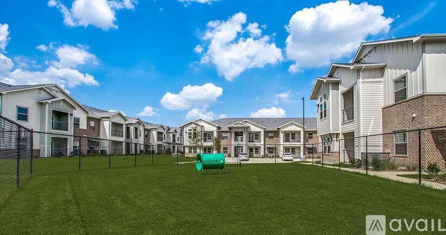 A row of houses with a green lawn in front and a sign that says "available".