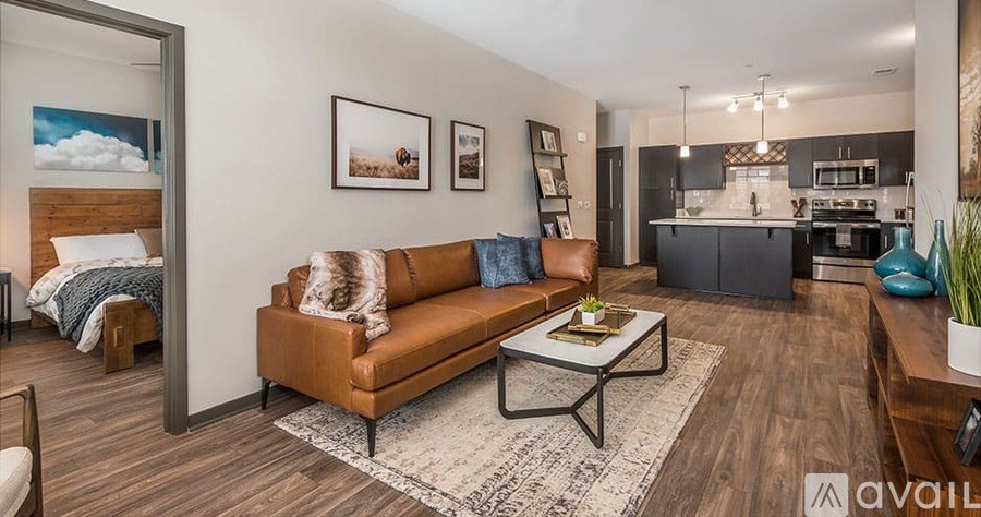A living room with a brown couch and a coffee table in the center.