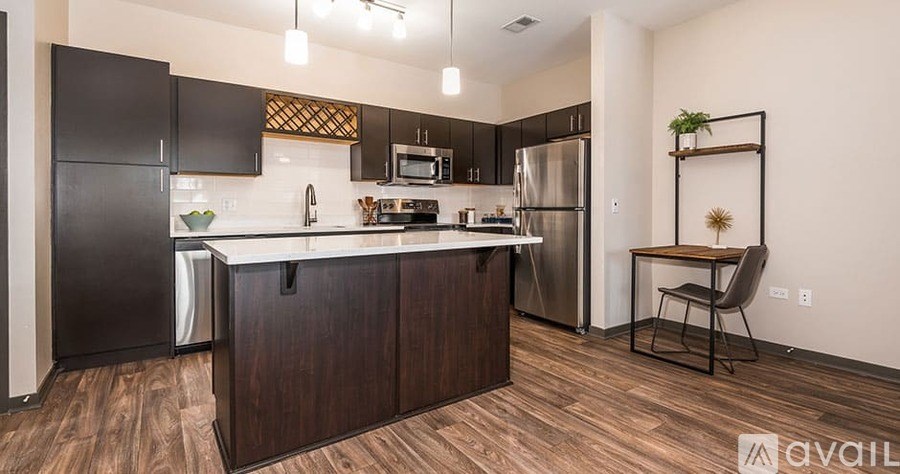 A kitchen with dark wood cabinets and a white countertop.
