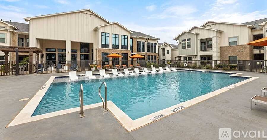 A large swimming pool in front of a building with a sign that says "AVAIL".
