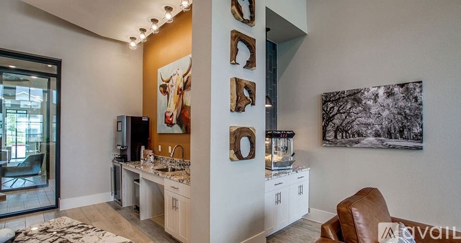 A living room with a brown leather chair and a painting of a cow on the wall.