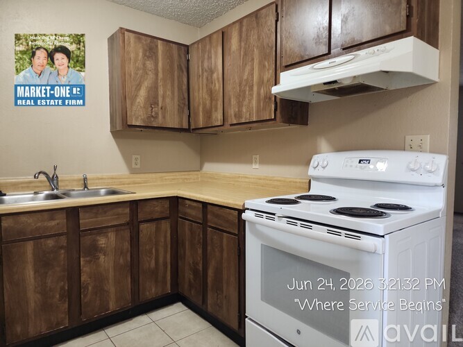 A kitchen with a white refrigerator and a white stove top oven.