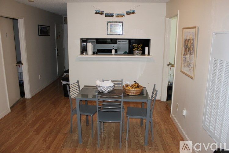 A dining room with a table set for two.