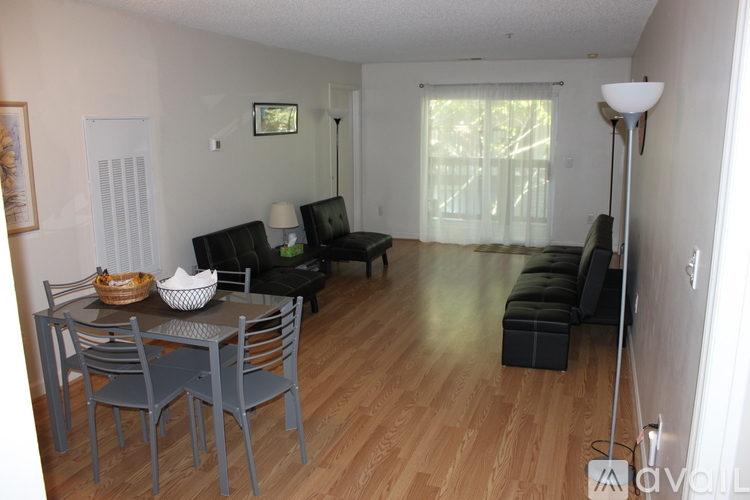 A living room with a grey table and chairs.