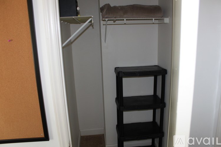 A small room with a shelf and a chair.