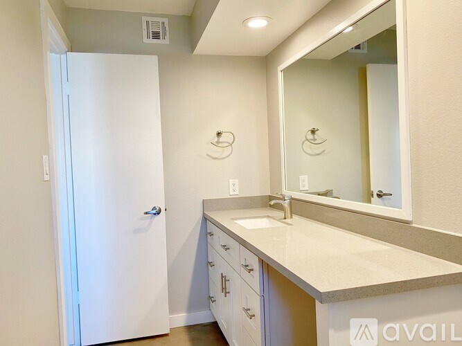 A bathroom with a sink, mirror, and medicine cabinet.