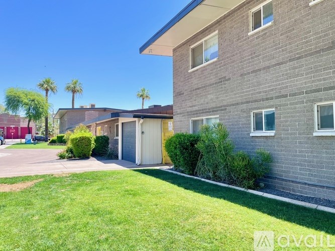 A grey building with a white door and windows.