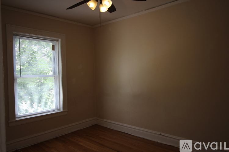 A room with a window and a ceiling fan.
